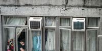 HONG KONG, CHINA - JANUARY 24: A couple looks down of a residential building in a locked-down part of the Jordon district on January 24, 2021 in Hong Kong, China. Hong Kong announced a sudden lockdown of a city block on Friday, with short notice given to residents and businesses. The group of nearly 200 buildings was located in Yau Tsim Mong, a densely-packed neighbourhood that squeezes in more than 10,000 people in the space of a square kilometre. The area has been the epicentre of a spiralling Covid-19 outbreak, and is home to many of the city's ethnic minorities. People live in cramped, often illegally subdivided flats with shared sanitation facilities, unable to access housing in the rest of a metropolis because of sky high rents. Far from the gleaming skyscrapers of Victoria Harbour, residents inside the lockdown zone found themselves locked into tiny spaces - sometimes entire families squeezed into one room of 100 square feet. Residents took to windows and rooftops to see through a harrowing weekend locked in. (Photo by Anthony Kwan/Getty Images)