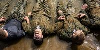 Naval Academy Plebes do sit ups during the "Wet and Sandy" portion of the annual Sea Trials at the U.S. Naval Academy on May 16, 2023 in Annapolis, Maryland. For the annual Sea Trials, the Naval Academy freshman class took part in a 14-hour series of rigorous exercises starting in the early hours of the morning as part of the culmination of their "Plebe" year at the academy. (Photo by Anna Moneymaker/Getty Images)