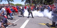 BRACKENFELL, SOUTH AFRICA - NOVEMBER 20: Police disperse crowds with teargas during the EFF Mass Protest on November 20, 2020 in Brackenfell, South Africa. The protest action follows a controversial incident at Brackenfell High School where a group of students and teachers were accused of hosting a private, ‘whites-only’ matric dance. (Photo by Gallo Images/Brenton Geach)