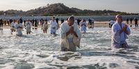 IWAKI, JAPAN - MARCH 11: Buddhist monks pray for the victims of the 2011 Tohoku earthquake and tsunami at a beach on March 11, 2021 in Iwaki, Japan. Japan will today observe the 10th anniversary of the 2011 Tohoku earthquake, tsunami and triple nuclear meltdown in which almost 16,000 were killed and hundreds of thousands made homeless. The magnitude 9.0 earthquake was one of the most powerful ever recorded. It triggered tsunami waves up to 40.5 meters high that travelled at 700km/h and surged up to 10km inland destroying entire towns. It moved Japan’s main island of Honshu 2.4m east, shifted the Earth on its axis by estimates of between 10cm and 25cm and increased the planet’s rotational speed by 1.8 microseconds per day. (Photo by Yuichi Yamazaki/Getty Images)
