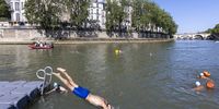 People swim in the Seine river after the Paris Mayor demonstrated that it is clean enough to host the outdoor swimming events at Paris 2024 Olympic Games, in Paris, France, 17 July 2024. To cut costs, Paris authorities have used existing infrastructure wherever possible – including using the Seine River as a venue. EPA-EFE/ANDRE PAIN