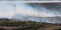Let the games continue- two games of football amid the chaos of firefighters and choppers fighting a blaze. Photographer: Rob Simmons<br>P4U_readersubmission_20250214