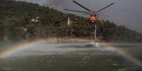 epa09401694 A Sikorsky S-64 Skycrane firefighting plane approaches an artificial lake to refill its water tanks as it operates in the area of Ippokrateios Politeia, near Athens, Greece, 06 August 2021. The fires in Attica continued to blaze uncontrollably on 06 August, along all three fronts that formed during the night - at the side of the Athens-Lamia national highway toward Kapandriti, on the foothills of Parnitha in Afidnes and in Ippokratios Politia where both homes and businesses were burned. Another major problem caused by the fires is the thick smoke that has blanketed the Attica sky, creating a stifling atmosphere. Among the forces fighting the flames are 83 fire-fighters sent from France, who arrived in Greece in the eraly morning hours the same day. The situation, already extremely difficult, is expected to get worse during the day as wind intensity picks up and starts to fan the flames.  EPA-EFE/KOSTAS TSIRONIS