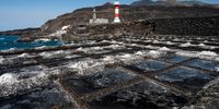 FUENCALIENTE, LA PALMA, SPAIN - OCTOBER 07: Traditional salt pans are seen covered by ashes from the Cumbre Vieja volcano on October 7, 2021 in La Palma, Spain. Cumbre Vieja Volcano erupted on September 19, shutting down the airport twice due to the volcanic ash. The numerous lava flows destroyed hundreds of hectares, but also formed peninsulas of volcanic rock, extending the surface of the island. (Photo by Marcos del Mazo/Getty Images)