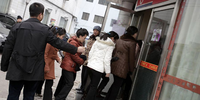 A group of North Korean women on the streets of Dandong in March 2023 being overseen by a North Korean government minder.Living in North Korea / The Outlaw Ocean Project