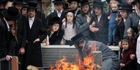 Ultra-Orthodox Jews pray as they burn leavened bread in the Mea Shearim neighborhood of Jerusalem, 11 April 2025. The burning of all products containing leavening agents, or Chametz, is a customary preparation ahead of the week-long Jewish high holiday of Passover that commemorates the Jewish exodus from Egypt, according to the Bible. Passover will be celebrated from 12 April to 20 April this year.  EPA-EFE/ABIR SULTAN