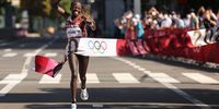 SAPPORO, JAPAN - AUGUST 07:  Peres Jepchirchir of Team Kenya celebrates as she crosses the finish line to win the gold medal in the Women's Marathon Final on day fifteen of the Tokyo 2020 Olympic Games at Sapporo Odori Park on August 7, 2021 in Sapporo, Japan.  (Photo by Clive Brunskill/Getty Images)