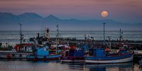 Almost Full Moon over False Bay, viewed from Kalk Bay Harbour. Photographer: NatGoldZA