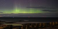 LOSSIEMOUTH, SCOTLAND - FEBRUARY 20: The Aurora Borealis is seen above WW2 beach defenses on February 20, 2021 in Lossiemouth, Scotland. The Aurora Borealis, more commonly known as the Northern Lights, occurs when solar winds drive charged particles from the sun which strike atoms and molecules in Earths atmosphere causing the light show. (Photo by Peter Summers/Getty Images)