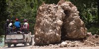 epa09421178 Rocks that fell during the earthquake block a part of the road that leads to Camp Perrin, Haiti, 19 August 2021. At least 2,189 people died and 12,268 were injured as a result of the 7.2 earthquake that devastated much of southern Haiti on August 14, in addition to substantial material losses, according to the latest official count.  EPA-EFE/ORLANDO BARRIA