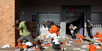 Looters empty a store of goods in the Springfield Value Centre in Durban on Monday, 12 July 2021. (Photo: EPA-EFE / STR)