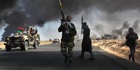 Libyan rebels battle government troops on 11 March 2011 in Ras Lanuf, Libya. (Photo: John Moore / Getty Images)