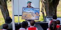 Bradley Gibbons, Endangered Wildlife Trust field officer, explains how endangered grey crowned cranes rely on wetlands to school children from Lydenburg during a World Wetlands Day awareness drive, De Berg Nature Reserve, Mpumalanga. (Photo: Julia Evans)