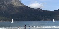 Walkers racing the yachts on Hout Bay Beach. Photographer: Chris van Ulmenstein