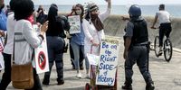 Protesters are warned by police to wear masks during the Covid-19 anti-vaccination march in Sea Point, Cape Town on 9 October 2021. (Photo: Gallo Images / Brenton Geach)