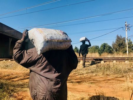 Coal hunters dodge the trains to scavenge for fallen rocks