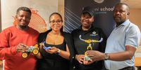 (From left) Teacher Bongani Godide, Olona Yywabi, Albertina Cossa and Teacher Gabriel Moengat seen at the Artificial Intelligence Lab holding AI robotics at Moses Kotane Primary in Braamfischer, Soweto. (Photo: Nhlanhla Phillips)