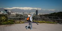 A firefighter wearing protective clothing, mask and goggles, sprays disinfectant on Tabia't bridge pedestrian overpass in Tehran, Iran, on Monday, March 9, 2020. The countrys health care system, burdened by U.S. sanctions and an ailing economy, has faced shortages in supplies and medicine as it fights to contain the crisis. Photographer: Ali Mohammadi/Bloomberg via Getty Images