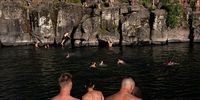 CLACKAMAS, OR - JUNE 27: Cliff divers line up along the Clackamas River at High Rocks Park at on June 27, 2021 in Portland, Oregon. Record breaking temperatures lingered over the Northwest during a historic heatwave this weekend. (Photo by Nathan Howard/Getty Images)