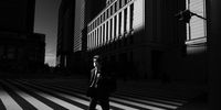 “Masked Man in Tokyo.” A scene in front of Tokyo Station during the declaration of a state of emergency related to Covid-19.” © Yasuhiro Takachi, Japan, 2nd Place, National Awards, Street Photography, 2022 Sony World Photography Awards