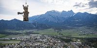 epa09161240 The sculpture 'Der Manipulator' by Swiss artist Markus Meyle is flown to the Guschakopf hill prior the international outdoor art exhibition 'Bad Ragartz' in Bad Ragaz, Switzerland, 26 April 2021. The exhibtion of 83 artist from 16 countries will display their works from 08 May 2021.  EPA-EFE/GIAN EHRENZELLER