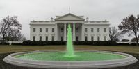 epa09080783 The fountain on the North Lawn is dyed green in celebration of St. Patricks day at the White House in Washington, DC, USA, 17 March 2021.  EPA-EFE/Chris Kleponis / POOL