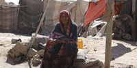 epa09813213 A displaced Yemeni woman sit outside a makeshift shelter at a camp for Internally Displaced Persons (IDPs) on the outskirts of Sana'a, Yemen, 09 March 2022. The World Food Programme (WFP) has warned that the Russian invasion of Ukraine is likely to further increase food prices in war-ravaged Yemen, which relies on wheat exports from both Russia and Ukraine, pushing millions into hunger as humanitarian funding dries up. Yemen has been pushed the brink of famine as a result of the prolonged war between the Houthis and the Saudi-backed government forces since March 2015, leaving 80 percent of the country's 30 million-population in dire need of food assistance, including over 4.2 million displaced people.  EPA-EFE/YAHYA ARHAB