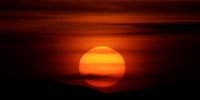 The sun sets over the mountains, as a geomagnetic storm continues hitting the Earth, in Ronda, Spain, May 12, 2024. REUTERS/Jon Nazca
