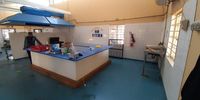 A staff member at KwaZulu-Natal’s Golden Steps school stands in an empty kitchen after the school’s appliances and food were looted.(Photo: Supplied by GroundUp)