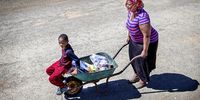 A woman and her son return home with their food parcel. (Photo: Donna van der Watt)