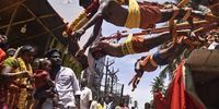 Hindu devotees with their backs pierced with metal skewers hang on a spinning carousel as part of a ritual during a procession to mark the 'Aadi' festival, at Nagavalli Amman temple, in Chennai, India, 30 July 2023. The Tamil holy month Aadi is the fourth month of the traditional Tamil calendar in the state of Tamil Nadu and it marks the beginning of the monsoon season. During this holy month, Tamil people visit Hindu temples to offer prayers and celebrate by performing rituals worshiping the Hindu gods.  EPA-EFE/IDREES MOHAMMED