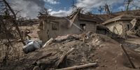 TAAL VOLCANO ISLAND, PHILIPPINES - JANUARY 14: Houses near Taal Volcano's crater are seen buried in volcanic ash from the volcano's eruption on January 14, 2020 in Taal Volcano Island, Batangas province, Philippines. The Philippine Institute of Volcanology and Seismology raised the alert level to four out of five, warning that a hazardous eruption could take place anytime, as authorities have evacuated tens of thousands of people from the area. An estimated $10 million worth of crops and livestock have been damaged by the on-going eruption, according to the country's agriculture department. (Photo by Ezra Acayan/Getty Images)