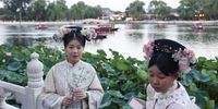 Tourists in traditional costumes pose for a photo near Houhai lake in Beijing, China, 07 August 2025.  EPA/WU HAO