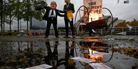 Activists from Ocean Rebellion set a boat alight next to the River Clyde, opposite a COP26 venue in Glasgow on 27 October 2021. (Photo: Jeff J Mitchell/Getty Images)