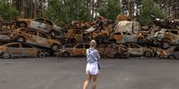 epa10016574 A woman looks at the pile of burned cars destroyed during Russian attacks in Irpin, Ukraine, 16 June 2022. The Ukrainian town of Irpin near Kyiv (Kiev), became a battlefield site when the Russian army attacked the Kyiv region in an attempt to reach Ukraine?s capital. Irpin was heavily shelled, causing death and destruction. At the end of March, when the town was taken back by the Ukrainian army, the mayor of Irpin announced that around 300 civilians and 50 Ukrainian servicemen were killed in Irpin during the Russian attacks. On 24 February Russian troops had invaded Ukraine resulting in fighting, deaths and destruction and a humanitarian crisis in the country.  EPA-EFE/ROMAN PILIPEY