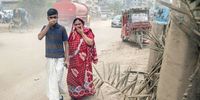 People cover their mouth and nose as they walk along an area surrounded by dust and smoke in Shampur, Dhaka, Bangladesh, 29 August 2023. Dhaka continues to be ranked as one of the world's most polluted cities, with debris from construction, industrial pollution, vehicle emissions and brick kilns listed as major contributors to air pollution in the city. According to the Air Quality Life Index (AQLI) Bangladesh is one of the most polluted countries in the World. Fine particulate air pollution (PM2.5) shortens the average Bangladeshi resident’s life expectancy by 6.8 years, relative to what it would be if the World Health Organization (WHO) guideline of 5 µg/m³ was met.  EPA-EFE/MONIRUL ALAM