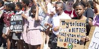 11-year-old environmental activist Yola Mgogwana holds a sign saying “try to leave earth a better place than when you arrived’ at the Fridays For Future and Extinction Rebellion protest outside Parliament on March 15. Photo: Tessa Knight