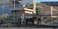 Two men on a donkey cart arrive at the Bheki Mlangeni Hospital to remove Tyre and other debris last week during the Nehawu wage strike. (Photo: Bheki Simelane)