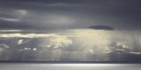 Sunday morning's storm passing over the Hottentots Holland Mountains, with Strand in the foreground and Sir Lowry's Pass, wet and glimmering, to the right. <br>