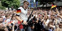 German saxophon player Andre Schnura plays to fans gathering in the centre of Stuttgart before the UEFA EURO 2024 quarter-finals soccer match between Spain and Germany, in Stuttgart, Germany, 05 July 2024.  EPA-EFE/RONALD WITTEK