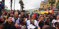 Fans walk alongside the buses in Cape Town during the Rugby World Cup 2019 Champions Tour. (Photo: Tevya Shapiro)