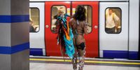 A carnival participant travels on the tube to the Notting Hill Carnival adults parade in London, Britain, 25 August 2025. The Notting Hill Carnival is the largest street carnival in Europe and is a community-led celebration of Caribbean history and culture. Celebrating its 59th year, the event runs on August 24 and 25 in 2025.  EPA/TOLGA AKMEN