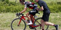 Australian rider Richie Porte (L) of the BMC Racing Team is helped by a mechanic after a flat tire during the 2nd stage of the 105th edition of the Tour de France cycling race over 182.5km between Mouilleron-Saint-Germain and La Roche-Sur-Yon, France, 08 July 2018.  EPA-EFE/SEBASTIEN NOGIER