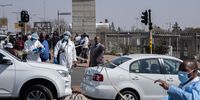 A forensic police officer at a crime scene at the Maponya mall in Soweto on 14 August, the day after gunmen killed a ride-hailing driver at the mall. (Photo: Emmanuel Croset / AFP)