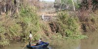 Local farmers pole their home-made boats along the Phongola River to reach crop fields inside the game reserve image Tony Carnie