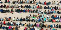 In an aerial view, migrants are seen grouped together while waiting to be processed on the Ciudad Juarez side of the border on September 21, 2023 in El Paso, Texas. A recent surge of migrant crossings have occurred along the Southwestern region of the United States border. (Photo by Brandon Bell/Getty Images)