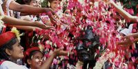 Indian school children throw flowers over a statue of Mahatma Gandhi as they pay their respects during the Gandhi Jayanthi celebration that marks Gandhi's birth anniversary in Bangalore, India, 02 October 2023. Gandhi Jayanti is celebrated annually across India on 02 October, to mark the birthday of Mohandas Karamchand Gandhi. This year marks the 154th birth anniversary of Mahatma Gandhi, also known as the father of the Indian nation.  EPA-EFE/JAGADEESH NV