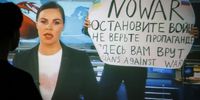 epaselect epa09826233 A woman watches a recorded feed of the Russian Channel One's evening news broadcast TV show in which an employee enters Ostankino on-air TV studio with a poster reading ''No War. Stop the war. Don't believe the propaganda. You are being lied to here" in Moscow, Russia, 15 March 2022. The on-air protest was staged on 14 March by Marina Ovsyannikova, who worked as an editor. She was taken to the Ostankino police department. A protocol was drawn up against an employee of Channel One under the article on military censorship for discrediting the Russian armed forces. On 24 February Russian troops had entered Ukrainian territory in what the Russian president declared a 'special military operation', resulting in fighting and destruction in the country, a huge flow of refugees, and multiple sanctions against Russia.  EPA-EFE/DSK