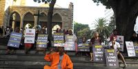 12/02/2020 PUBLIC RALLY State Capture Culprits Must Be Jailed - Year of the orange overalls at St George's Cathedral, Cape Town. Ali Gule, National community engagement facilitator for OUTA- man in orange overall.<br>Story Christy Nortier<br>Picture JOYRENE KRAMER