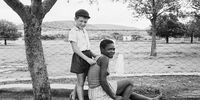 A farmer's son with his nursemaid, Heimweeberg, Nietverdiend, Western Transvaal. 1964. David Goldblatt/Goodman Gallery